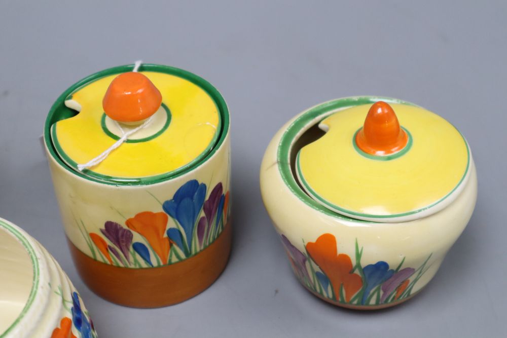 Five Clarice Cliff crocus preserve jars and two covers, tallest 8.5cm